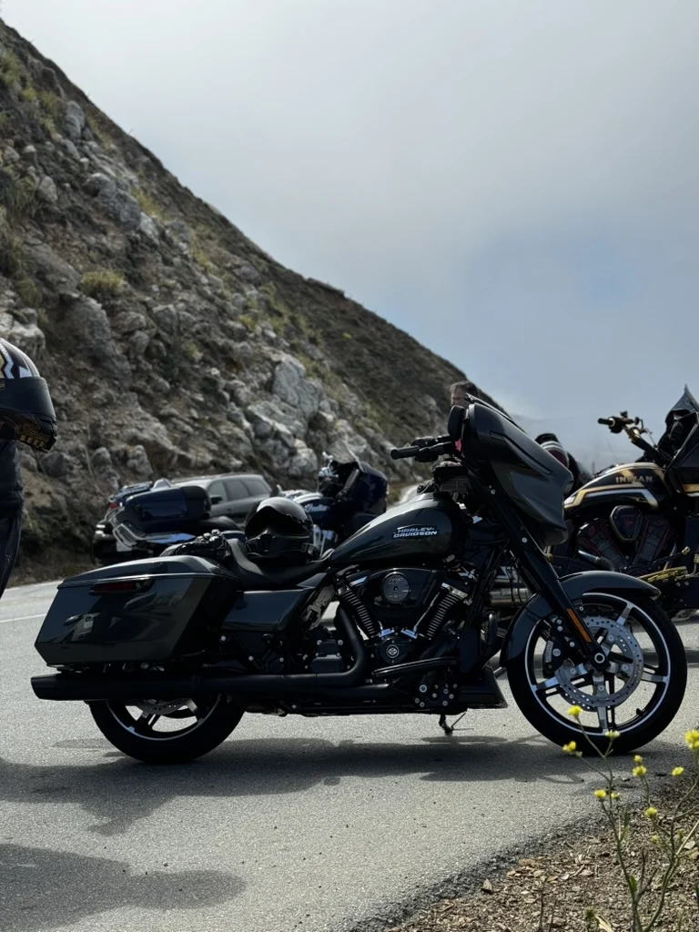 Side profile of the 2025 Street Glide FLHX parked somewhere off the PCH—possibly Carmel. Scenic curves, coastal air, and the Iron Horse Metallic catching every bit of California light.