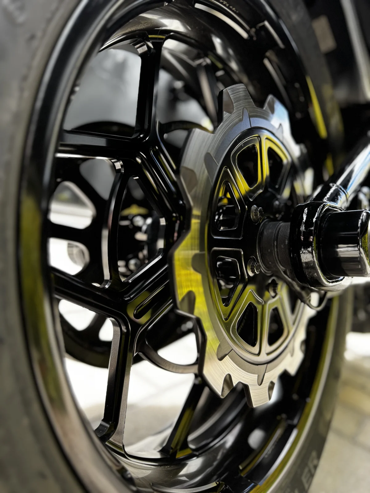 Sleek and performance-driven—black rotors and front caliper repositioning from Lyndall Brakes, complemented by Arlen Ness rims for a sharp, dynamic look.